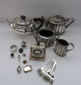 A porcelain desk clock, together with epns teapots, vesta case, nutmeg grater etc