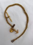 A 15ct yellow gold Albert chain with an anchor and heart charm, totalling approximately 38 grams