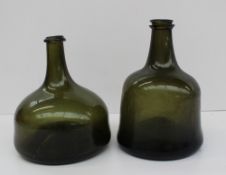 An 18th century light green mallet shaped wine bottle, 19cm high, together with a squat mallet