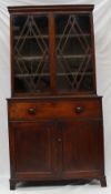 A 19th century mahogany bookcase, the moulded cornice above a pair of glazed cupboards, the base