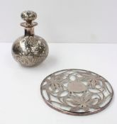 A glass scent bottle overlaid with white metal with scrolling and leaf decoration, together with a