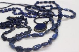 A lapis lazuli pendant and bead necklace together with other lapis lazuli bead necklaces