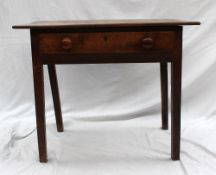 An early 19th century oak lowboy, the rectangular planked top above a frieze drawer on square legs,