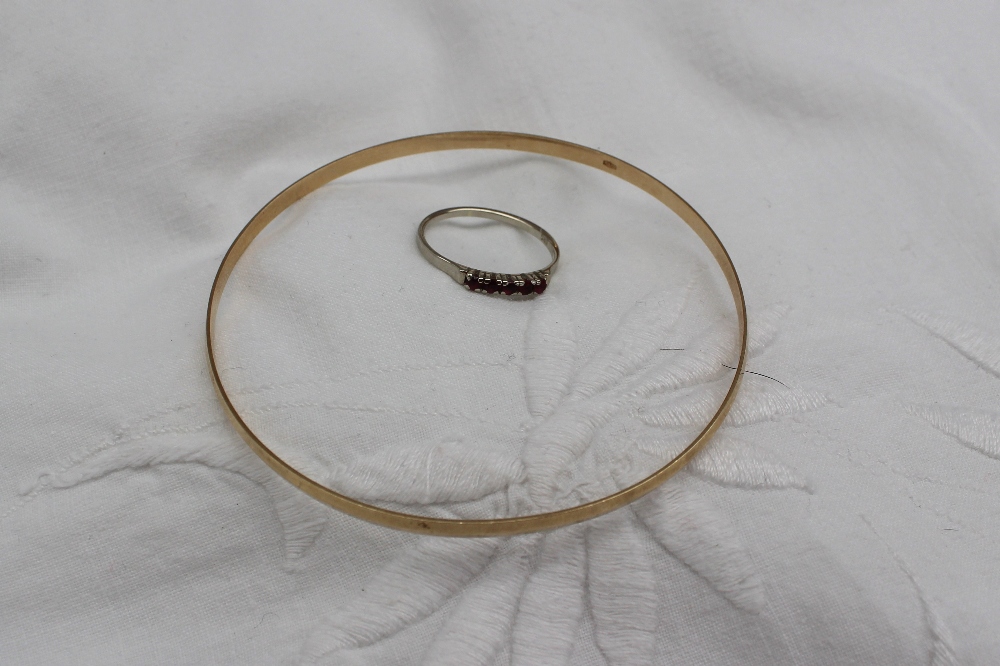 A 9ct yellow gold faceted bangle approximately 4.5grams, together with a five stone ring