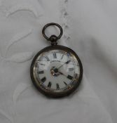 A silver fob watch the enamel dial with Roman numerals, floral and gilt highlights inscribed Robert