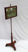 A Victorian mahogany pole screen, the rectangular screen with silkwork decoration of a garden scene