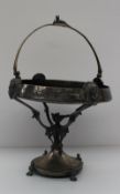A Reed & Barton electroplated swing handled basket with fox surmount, mask sides, scrolling stand