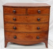 An early 19th century mahogany chest, the bow fronted top above two short and three long drawers on