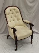 A William IV mahogany framed spoon back library chair, with a button back and pad seat, the arms