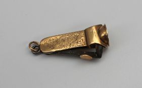 A 9ct yellow gold cigar cutter, with scroll and flower decoration