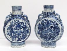 A pair of Chinese blue and white moon flasks each applied with twin dragon handles to the shoulder,