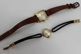 A ladies 18ct yellow gold Omega wristwatch, the square silvered dial with batons on a leather strap