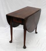 A 19th century mahogany drop leaf dining table, the oval top with drop flaps on tapering legs and