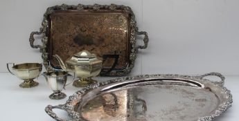 A large electroplated twin handled tray together with another tray and a three piece tea set