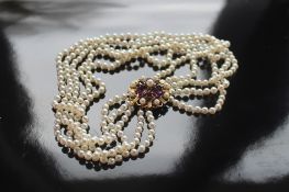 A five strand pearl choker, the 9ct yellow gold clasp set with amethyst and seed pearls, 36.5cm