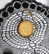 An Edward VII  gold sovereign dated 1902, in a 9ct yellow gold slip mount