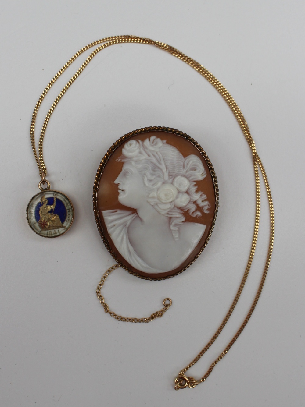 A shell cameo brooch depicting a classical maiden in profile  in a yellow metal surround, together