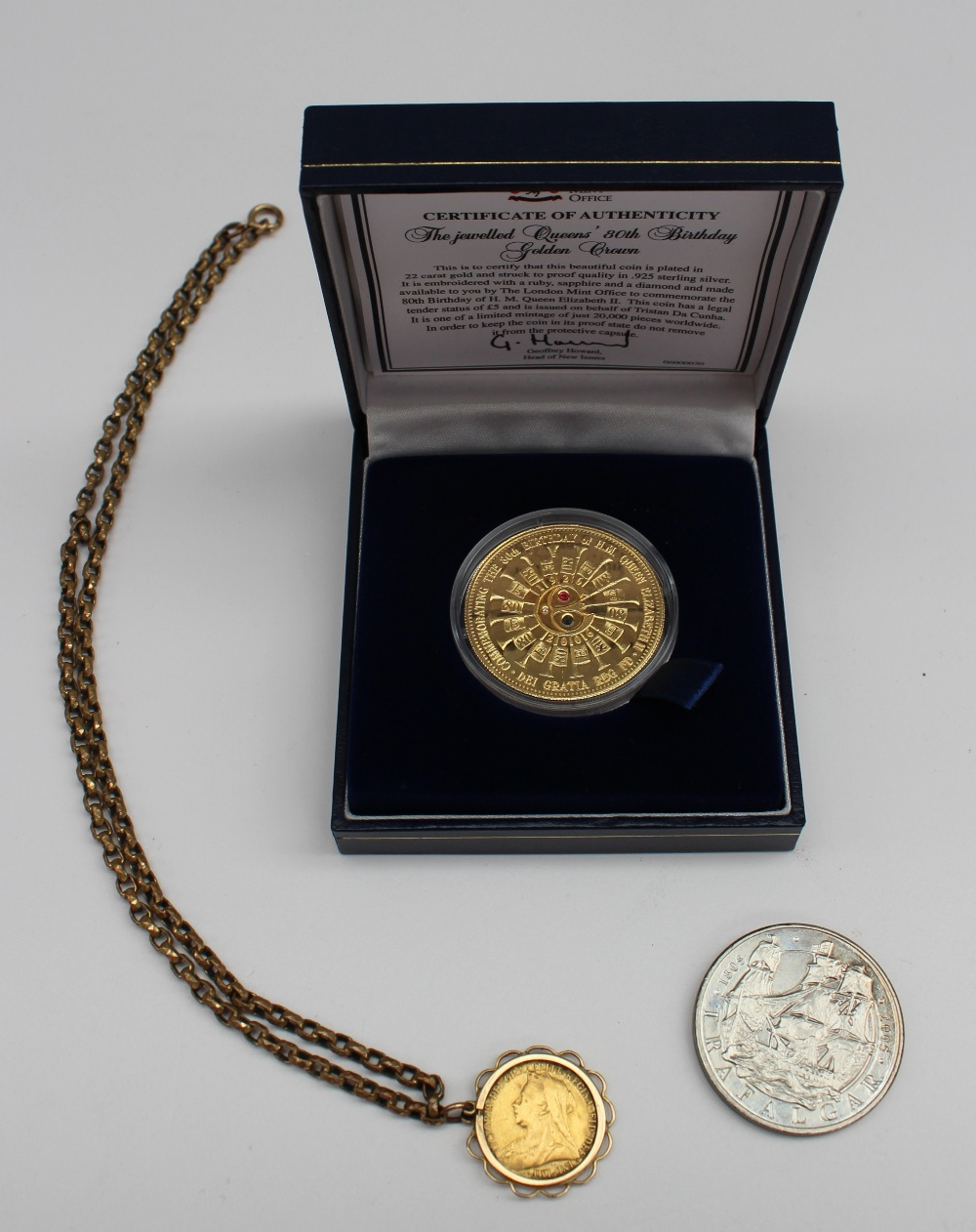 A Victorian gold sovereign dated 1901 in a yellow metal mount together with a London Mint coin ``