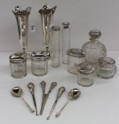 A pair of silver bud vases together with a collection of silver topped and glass dressing table