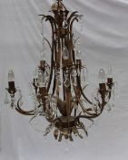 A modern bronze effect nine branch chandelier with leaf and lustre drop decoration, together with