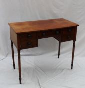 A Victorian mahogany side table, the rectangular top above a cupboard and drawers on ring turned