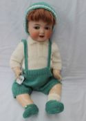 A Simon & Halbig bisque head doll with closing flirty eyes, open mouth, teeth and movable tongue, to
