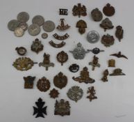 A collection of military cap badges including the Royal Corps of Signals, Royal Berks, Essex,