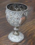 A Victorian silver goblet, with a beaded rim, embossed with stylised flowers heads on a beaded