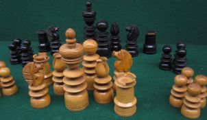 A turned treen "Calvert" type part chess set, one side stained black, the other natural, the kings