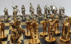 A Franklin Mint Tournament and Camelot chess set, crafted in pewter and plated in silver and gold,