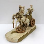 A Royal Dux figure group modelled as a classical chariot driven by a standing male wearing a