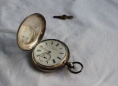 A late Victorian silver hunter key wound pocket watch, the enamel dial with Roman numerals and a