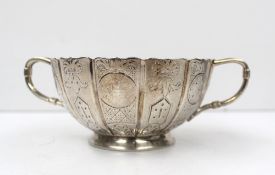 A Victorian silver twin handled bowl of panelled form decorated with leaves and roundels, London,