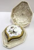 A continental porcelain box and cover, of pointed shaped form painted to the top with birds in a
