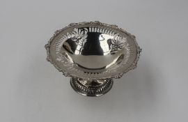 An Edward VII silver pedestal Bon Bon dish, with a cast rim and pierced edge, London, 1904, George