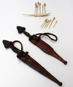 Two African daggers with spear ends and leather grips and scabbards together with bone cocktail