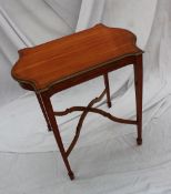 A late Victorian/Edwardian satinwood occasional table, the shaped crossbanded top above a shallow