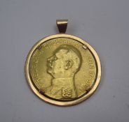 A yellow metal coin on the one side is a portrait in profile of Friedrich II Grossherzog Von