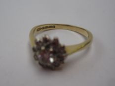 A Diamond cluster ring set with old cut stones to a white metal claw setting and an 18ct yellow gold