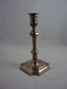 A late Victorian silver candlestick, the removable sconce above a ring turned top, squared