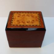 A lacquered walnut Rapport automatic watch winder, 19 cm wide.