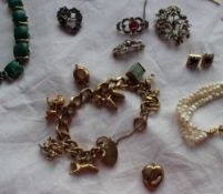 A 9ct yellow gold charm bracelet set with numerous charms including a stork, poodle etc,