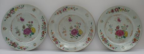 A set of three Chinese porcelain plates decorated with sprays of garden flowers
