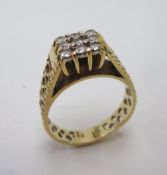 An 18ct yellow gold panel ring set with nine diamonds to a claw setting and pierced shank,