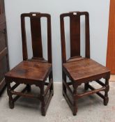 A pair of 18th century oak dining chairs with a rectangular splat above a solid seat on square