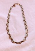 A yellow metal swag decorated necklace approximately 11 grams