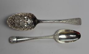 A George III silver berry spoon, the bowl embossed with cornucopia of fruit and flowers, London,