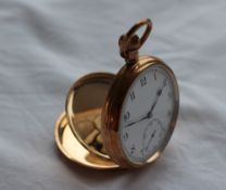 A 9ct gold keyless wound open faced pocket watch, the enamel dial with Arabic numerals and a seconds