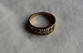 A diamond set panel ring, set with twelve brilliant cut diamonds to an 18ct yellow gold setting
