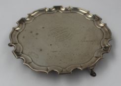 A Late Victorian silver salver, with a shaped edge on four pad feet, inscribed to the centre "
